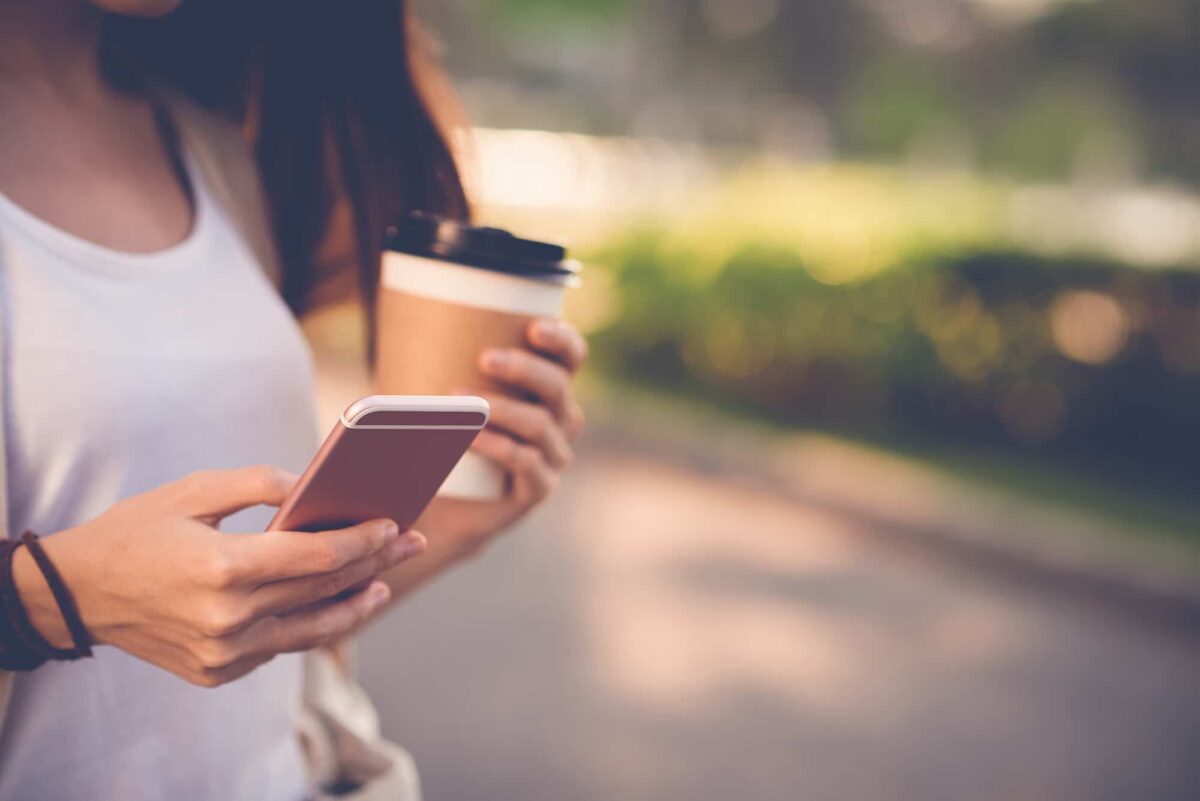 Girl on phone with coffee