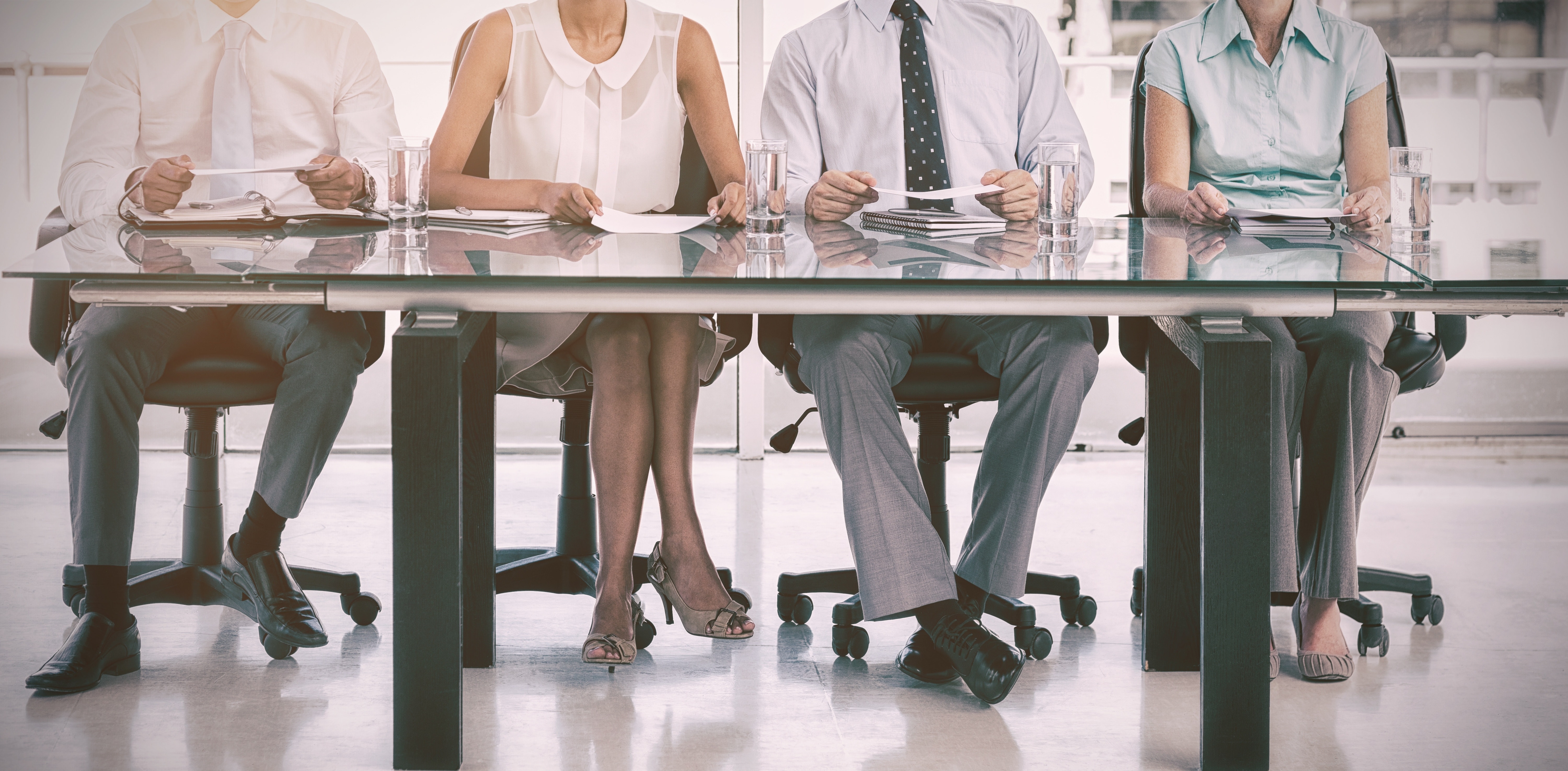Group of business people sitting at table FundCalibre