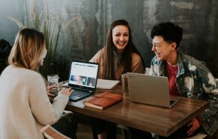 Three millennials working at table