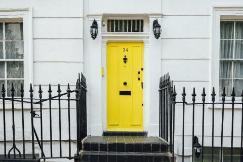 yellow door with whitewashed building