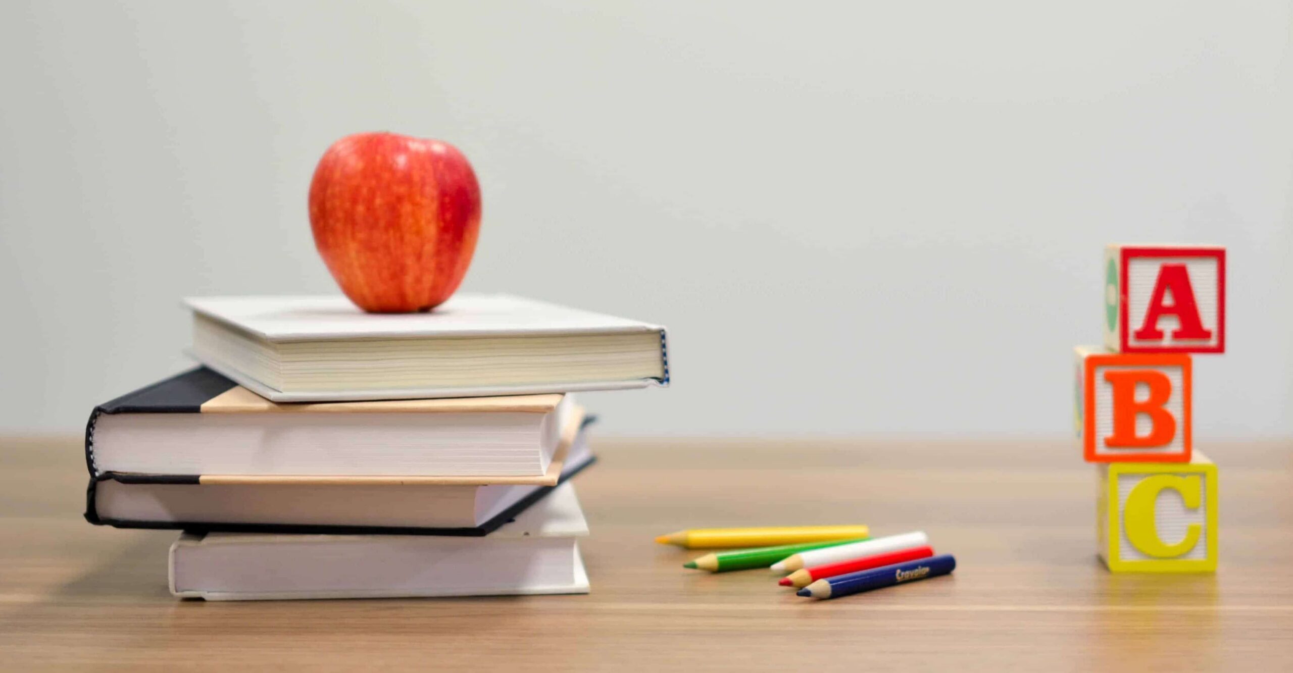 back to school apple on books with blocks