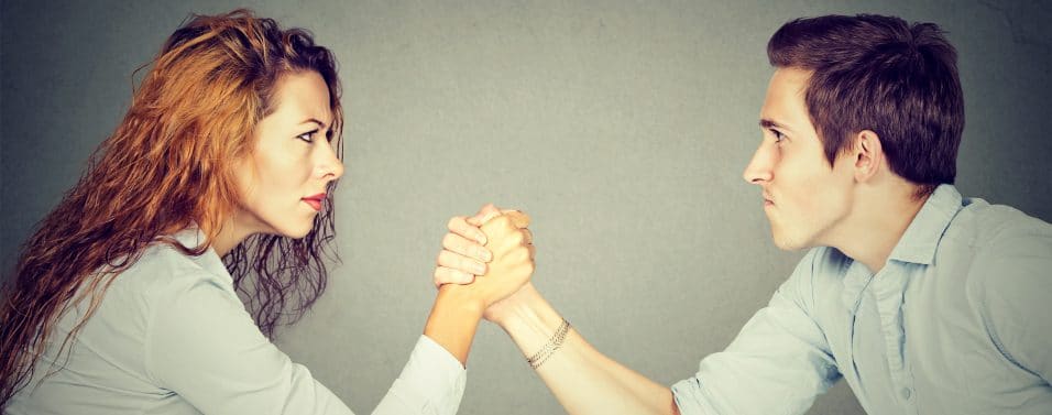 woman and man arm wrestling