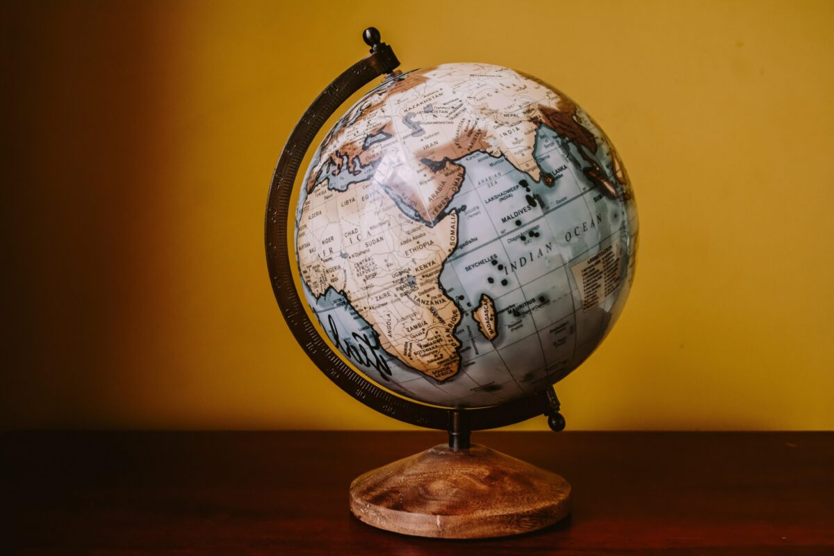 globe on desk with yellow background
