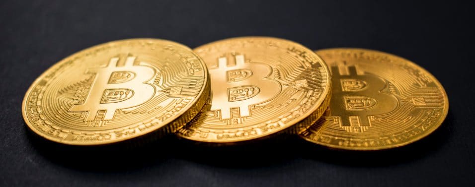 Three bitcoin on black background