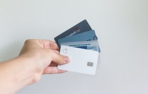 hand holding credit cards on white background
