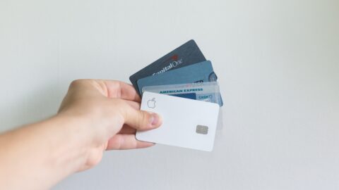 hand holding credit cards on white background