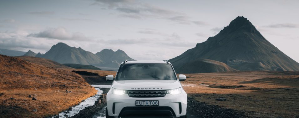 Land Rover Discovery driving in front of mountains
