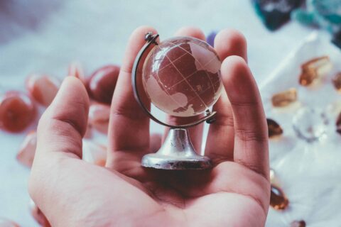 small glass globe in the palm of a hand