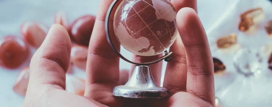 small glass globe in the palm of a hand