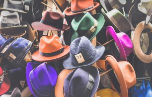 A choice of multi-coloured hats with prices in a large pile