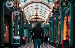 A man in an arcade choosing where to purchase something