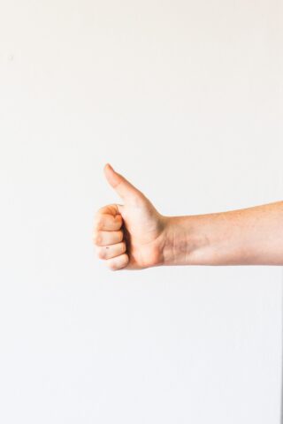 thumbs up signalling congratulations, well done, good job