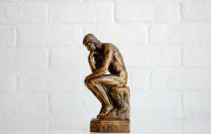 A statues of a man worrying about the world