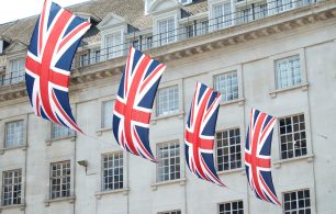 4 Union Kingdom flags fluttering against a London building