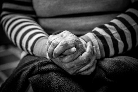 a pair of hands on an old person's lap