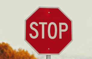 a red sign with white letters saying stop