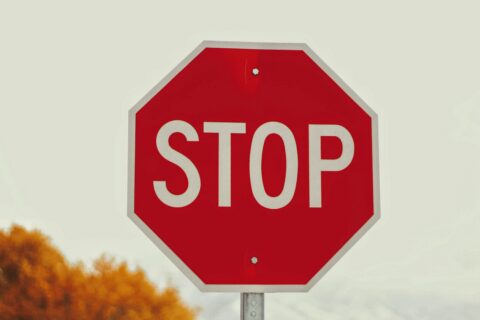 a red sign with white letters saying stop