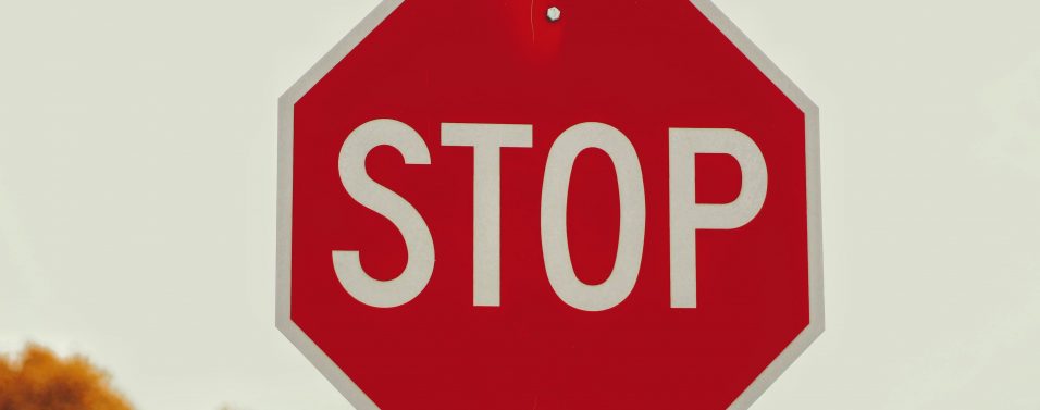 a red sign with white letters saying stop