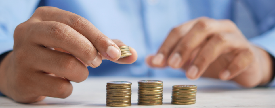 a man's hands counting income from his investments