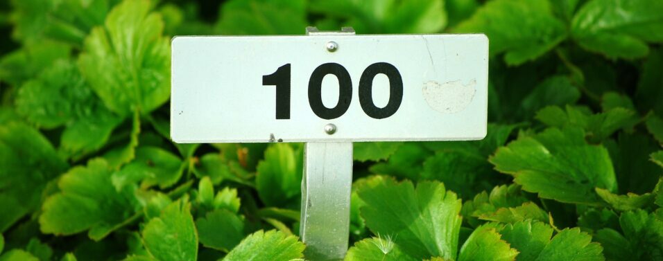 a sign with 100 on a green background