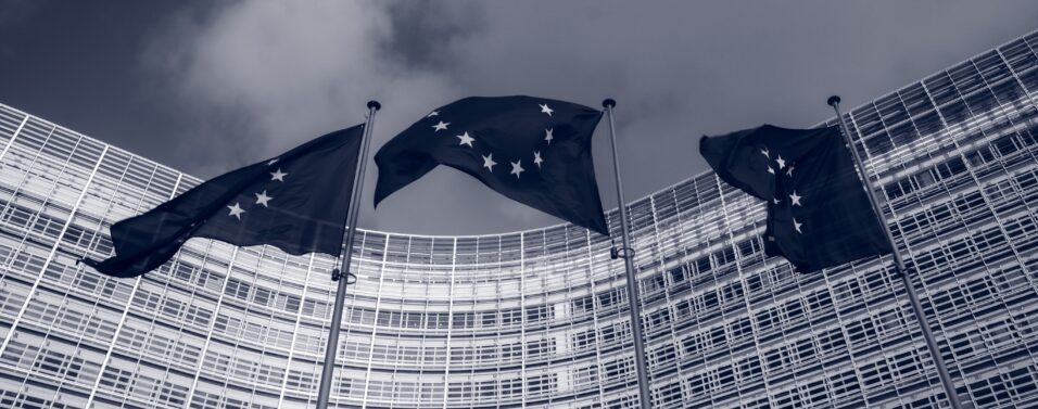 the European Central Bank with 3 EU flags blowing in front of it