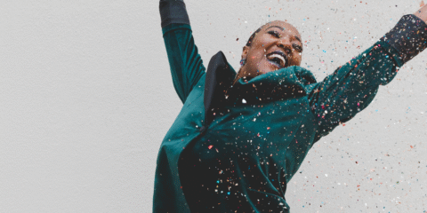 a woman celebrating the best mid-year funds