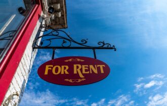 a for rent sign on a blue sky background