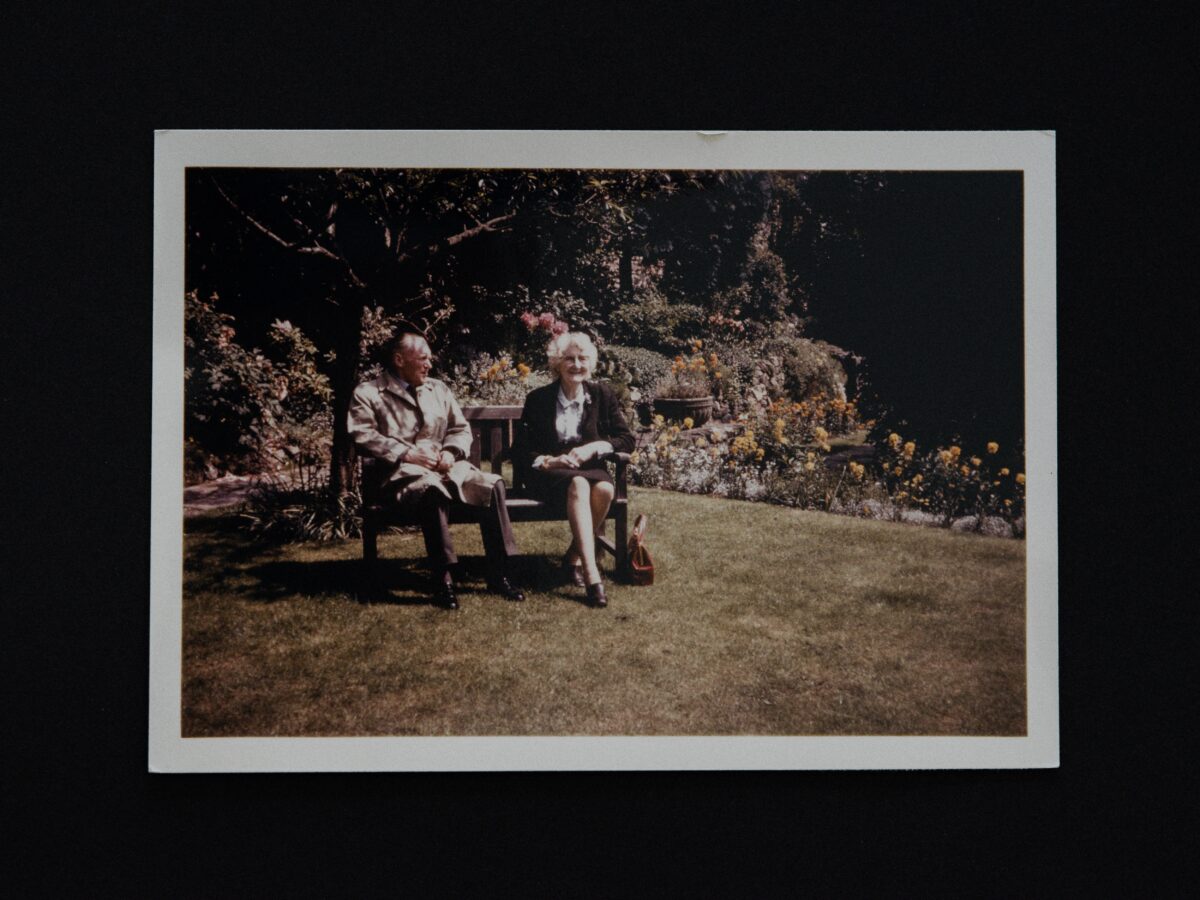 a photo of 2 old people sitting in retirement on a bench