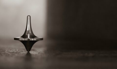 which way will the spinning top fall?